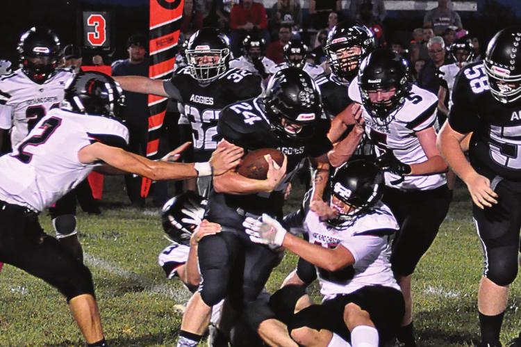 KELTON GORDON, a Hardin-Central junior, takes on a gang of Trailblazers as he carries the ball during the first half of Norborne Hardin-Central’s Oct. 1 homecoming meeting with Northland Christian at Norborne. SHAWN RONEY | Staff