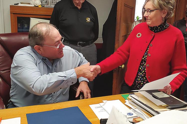 RAY COUNTY Eastern Commissioner Allen Dale receives a House resolution of recognition, upon his pending retirement, from state Rep. Peggy McGaugh during the commission’s Dec. 18 meeting. Behind them stands Presiding Commissioner Bob King. JANIS KINCAID | Submitted photo
