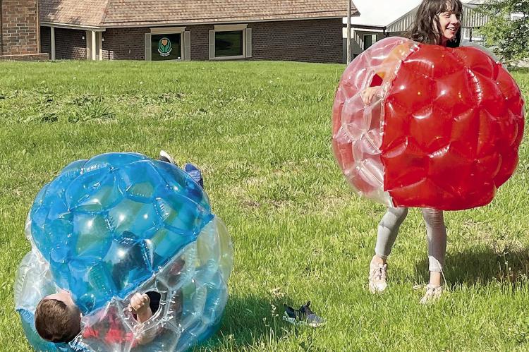 SOPHIA BALES | Staff BRAXTON GALARIADA (left) rolls in his bubble after his sister,Ryley, bumped him during the CAP event at Maurice Park in Richmond.