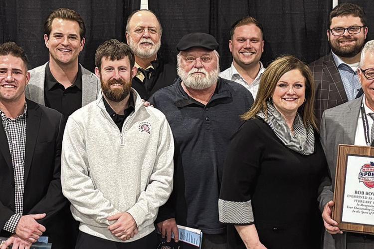SURROUNDED BY FAMILY AND FRIENDS, Coach Rob Bowers (holding plaque) is inducted into the Missouri Sports Hall of Fame. Submitted