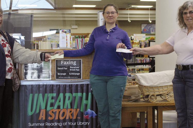 MAXINE HISTS (left) of Eastern Star Chapter 42 and Claudia Spooner (right) of Eastern Star Chapter 255 present $250 checks to Library Director Stacy Hisle for the summer reading program. SHARON DONAT | Staff