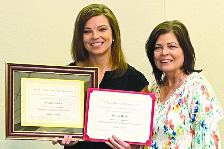 JESSICA BACKS (left) receives recognition as principal Sara Terrill looks on. Submitted
