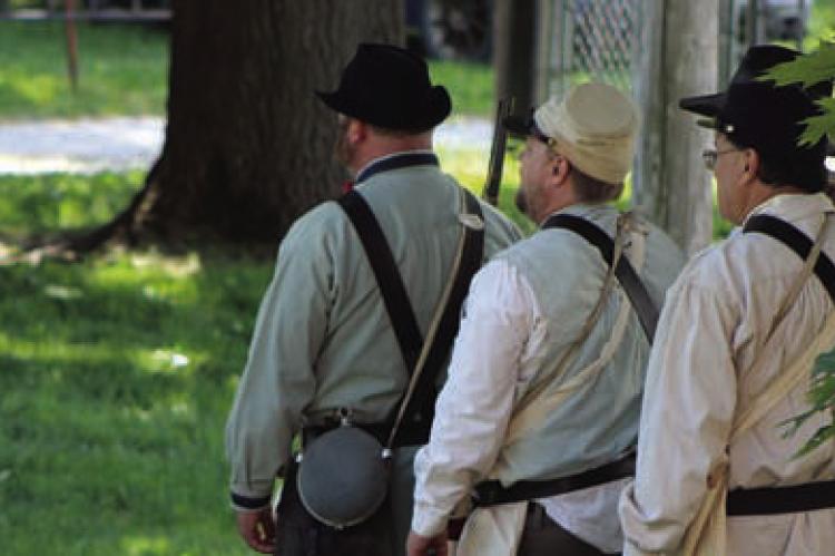 CIVIL WAR reenactors participate in a muster, demonstrating military drills and camp life during a living history event at the Ray County Museum. The event drew spectators interested in learning about the daily life of soldiers during the 1860s. SHARON DONAT | Staff