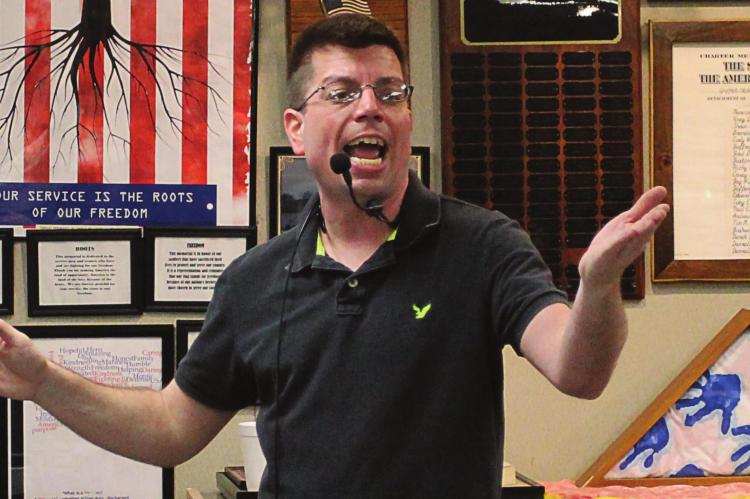 AT THE RAY COUNTY Veterans Memorial Community Building, auctioneer Steve Ritter takes bids for pens, inkwells, coins, watches and other collectibles. J.C. VENTIMIGLIA | Staff