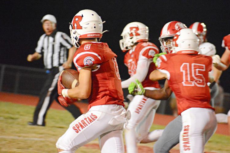 BAILON STOCKTON keeps the football tucked in his left arm as he takes a fourth-quarter interception to the house Sept. 16 against visiting Van Horn. SHAWN RONEY | Staff