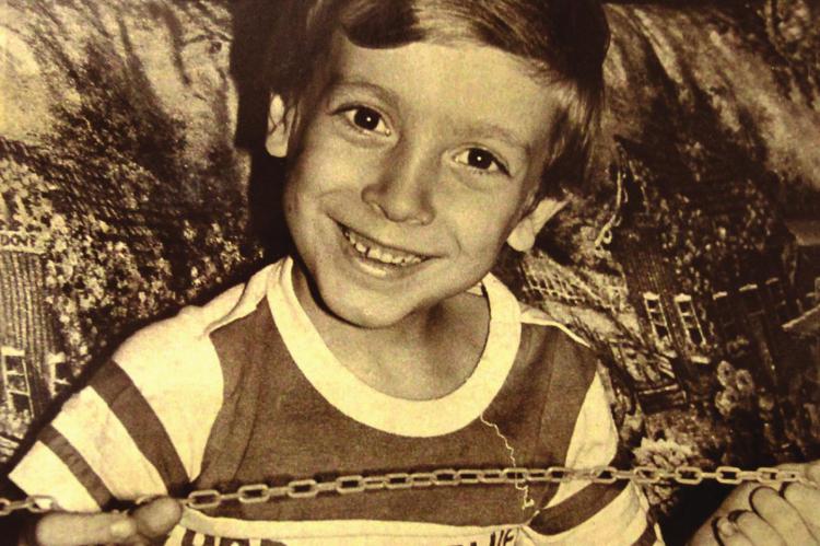 AT AGE 7 in 1987, Jason Robertson wants to go to school. He has AIDS and the community tries to keep him out, but the law is on his side. Community members carry signs and chant, “Back to the trailer,” a segregated classroom where he had been educated, on his first school day. J.C. VENTIMIGLIA | Granite City Press-Record/Journal