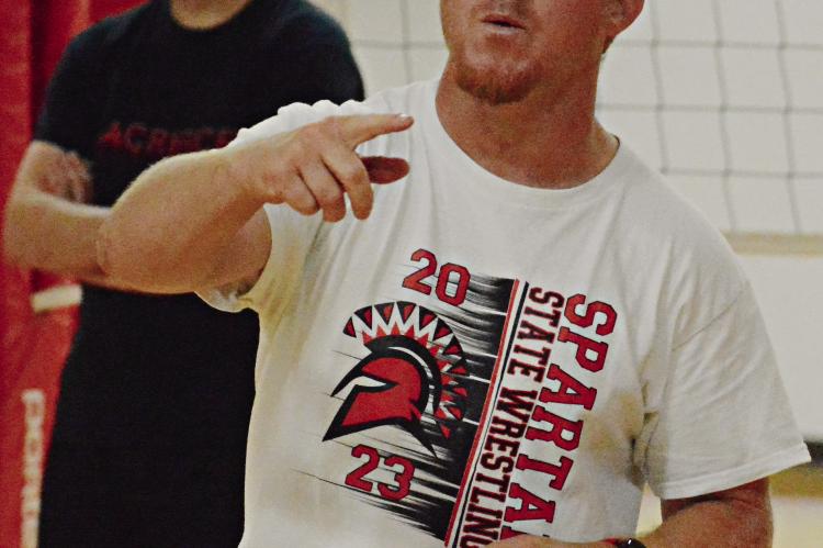 CODY HOGAN, who has added another coaching position to his responsibilities, talks to his Spartans during their end-of-summer team volleyball camp at Richmond High School. SHAWN RONEY | Staff