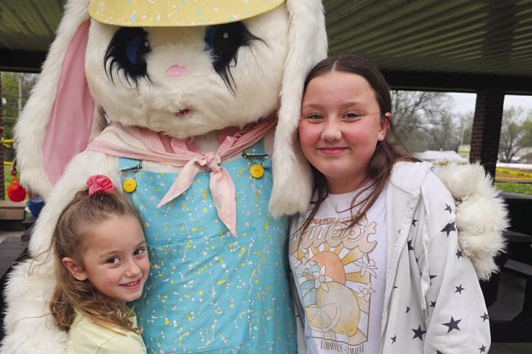 EVERLEE CLONINGER (left) and Oaklee Cloninger visit the Easter Bunny before racing for eggs at Maurice Roberts Park. Submitted