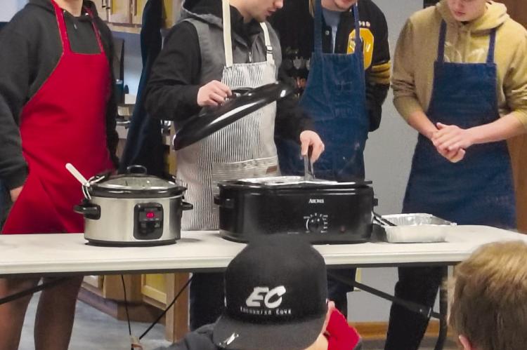 ORRICK FFA STUDENTS prepare food for the annual community breakfast, an event open to the public. FFA teacher Don Honeycutt said the event reflects the program’s purpose of service, adding, “This is our way of giving back to the community.” SHARON DONAT | Staff