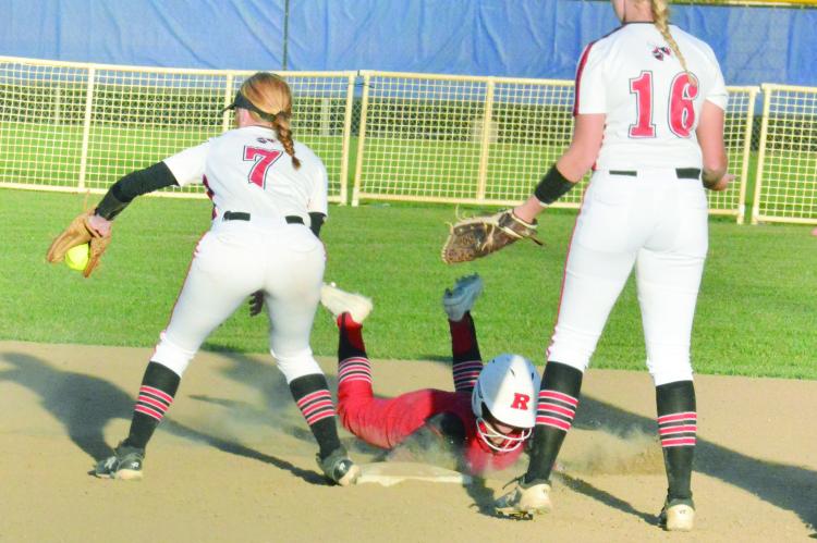 RICHMOND JUNIOR Sydney Appleberry dives safely back into second base between Chillicothe’s Kirsten Dunn, No.7; and Bre Pithan, No. 16, and to avoid getting caught in a rundown Oct. 13 in district play Oct. 13 at St. Joseph. SHAWN RONEY | Staff