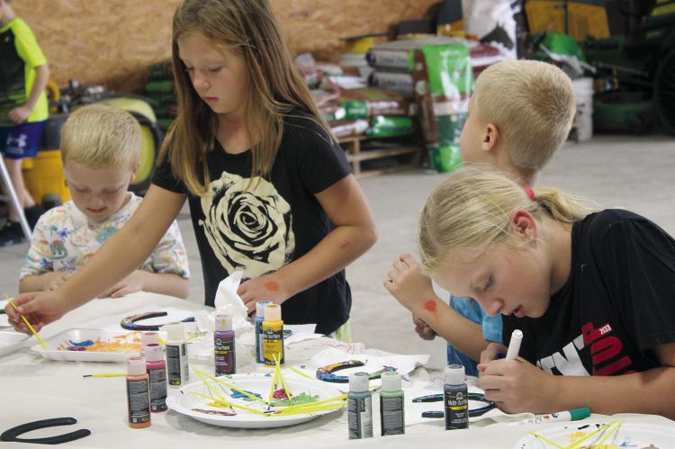 Finn (from left), Olivia, Del and Annabelle Jones put their creativity to work painting horseshoes at Aldrich Quarter Horses. “I liked the kids who wanted a horse because I was ‘that’ kid,” said Aldrich Quarter Horses Owner Janet Aldrich. “I shared never to give up on working and dreaming for a horse.”