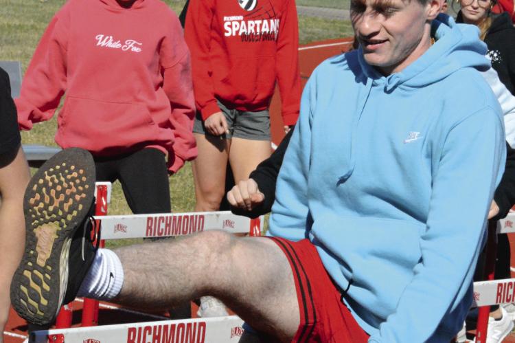 JUNIOR NOLAN QUICK, shown stepping sideways over hurdles, is among about 70 high schoolers out for track and field at Richmond. SHAWN RONEY | Staff
