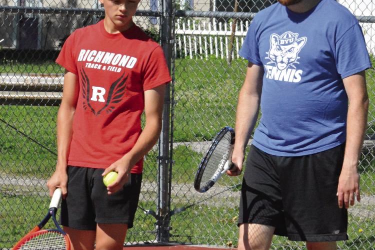 JAXON AHART (left) works on his game with Richmond Tennis Coach Zachary Baldauf. SHAWN RONEY | Staff