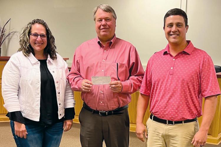 RICHMOND ROTARY members Becky Treccariche, left, and Doctor Ryan Lauck, right, present Mayor Mike Wright with a donation of $5,000 for the developing park project at North Main and College streets. Submitted