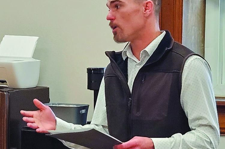 Inc. Benefits Advisor John Hickman reviews current coverage costs and pending quotes before commissioners. HEALTH INSURANCE COOPERATIVE Agency