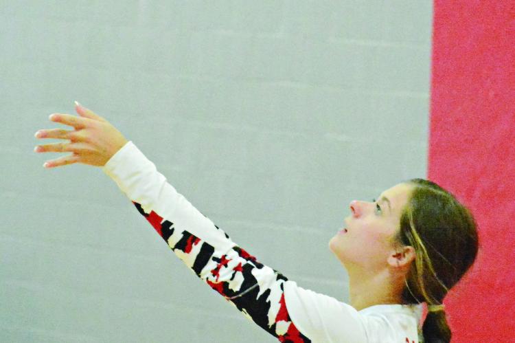 RICHMOND SENIOR Grace Bozarth keeps her eyes on the volleyball as she tosses it up to serve against Brookfield Sept. 30 in tournament play at Carrollton. SHAWN RONEY | Staff
