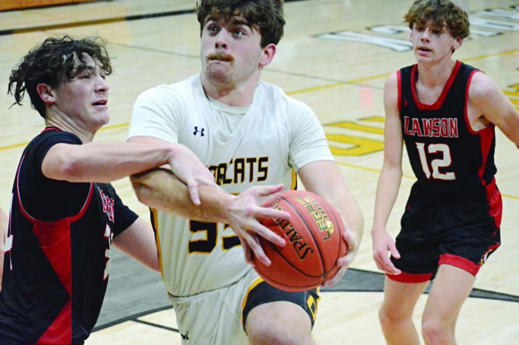 TUCKER GREER attempts a contested first-half layup during the Bearcats’ varsity boys basketball meeting Monday night with visiting Lawson, whose coaching staff includes former Orrick teacher and coach Mitch Comstock. SHAWN RONEY | Staff