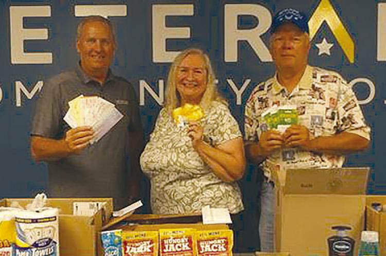 CHRIS ADMIRE (from left) accepted donations from OCC members Barbara and Mike Britt. Submitted