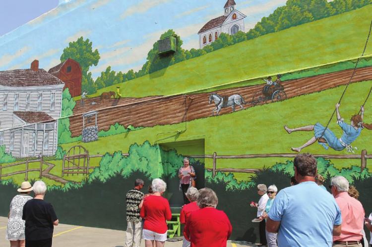 DURING THE DEDICATION of the Ray County Bicentennial Mural Sunday in downtown Richmond, Ray County Community Arts Association President Melinda White thanks people who make the mural a reality.