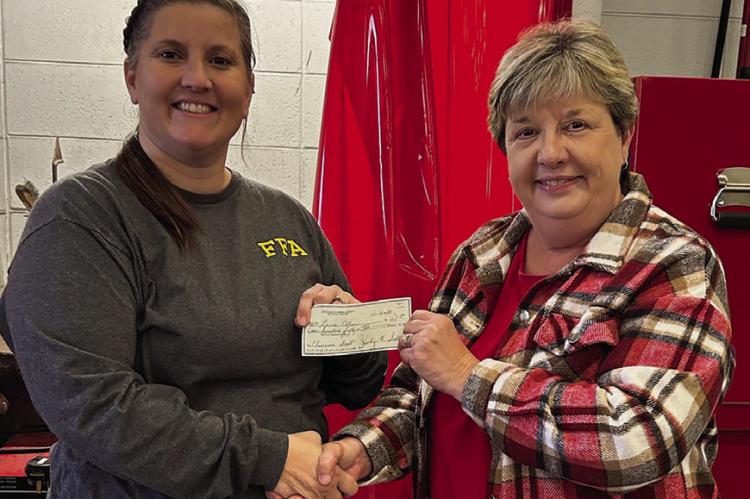 RICHMOND HIGH SCHOOL teacher Laura Allen (left) is awarded a $150 Classroom Impact Grant from Beta Tau representative Brenda Hamm to purchase three autodarkening welding helmets. Submitted