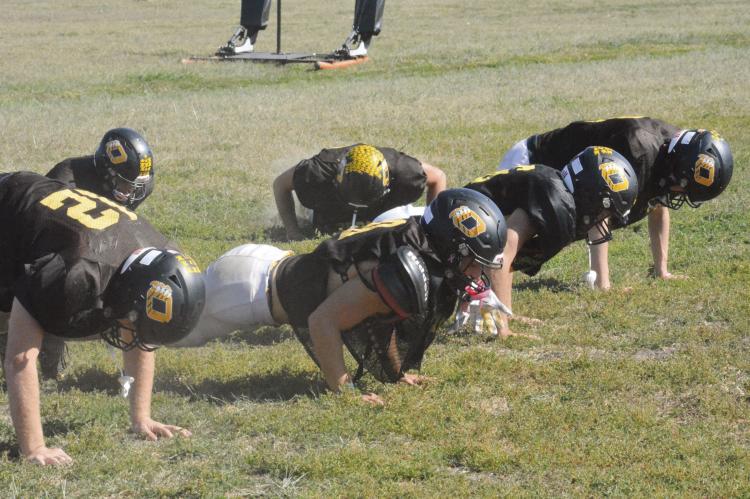 THE BEARCATS do up down exercises Tuesday on their practice field as they work toward their goal of posting a perfect season. They’ll attempt to take another step toward that goal Friday night, when they host Sweet Springs/ Malta Bend for homecoming. SHAWN RONEY | Staff