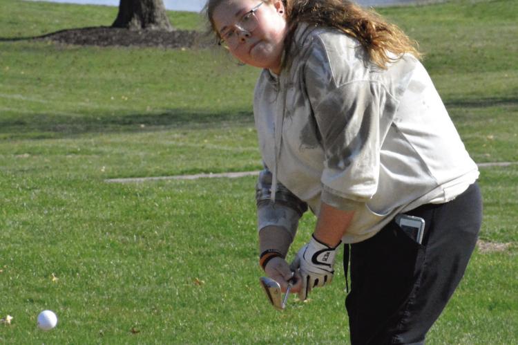 ORRICK SOPHOMORE Shelbie McElwee works on her short game Monday afternoon at the Excelsior Springs Golf Course. SHAWN RONEY | Staff