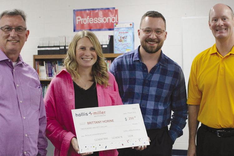 JOHN BROWN (from left), Brittany Horine, Cam Hinton and Dr. Bryan Copple discuss the $250 grant Horine won with Hollis and Miller Architects. SOPHIA BALES | Staff