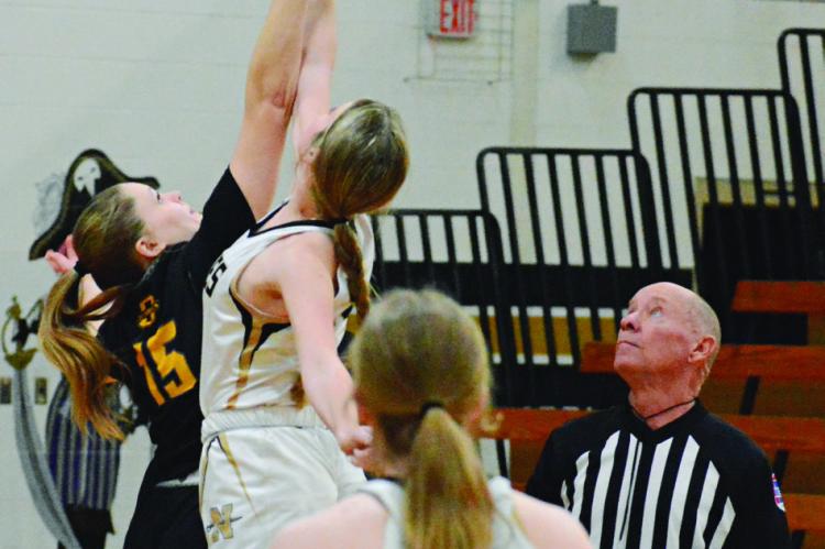 ORRICK SENIOR Natasha Hicks (No. 15) reaches high during the opening tipoff against Norborne.