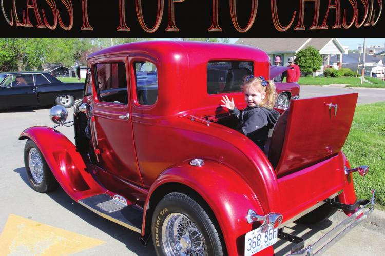 IN THE RUMBLE SEAT of a 1929 Ford Model A, Mercy Bolling, 3, waves to a family member. The vehicle belongs to Michelle Glunt, Excelsior Springs. J.C. VENTIMIGLIA | Staff