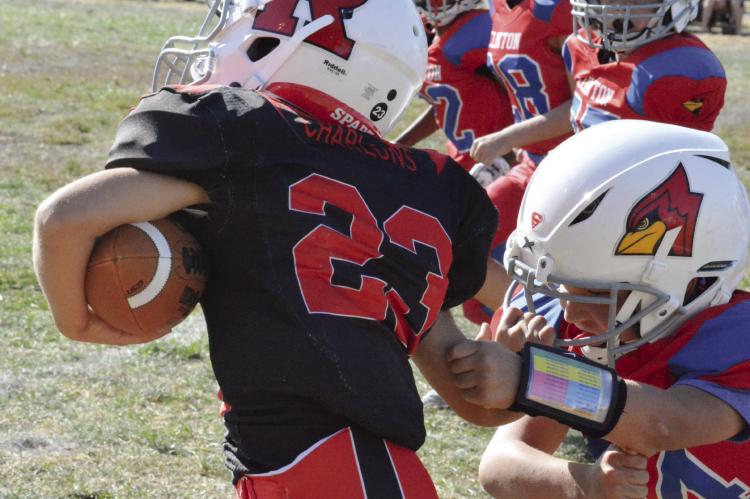 CALLING TO MIND Richmond High School running back Aidan Ivison, who also wears No. 23, Roman Charlons breaks a tackle as he rumbles for rushing yards during the second half of the Richmond third-grade team’s Oct. 22 meeting with Clinton in the West Central Youth Football League playoff semifinals at Dear Elementary Field. SHAWN RONEY | Staff
