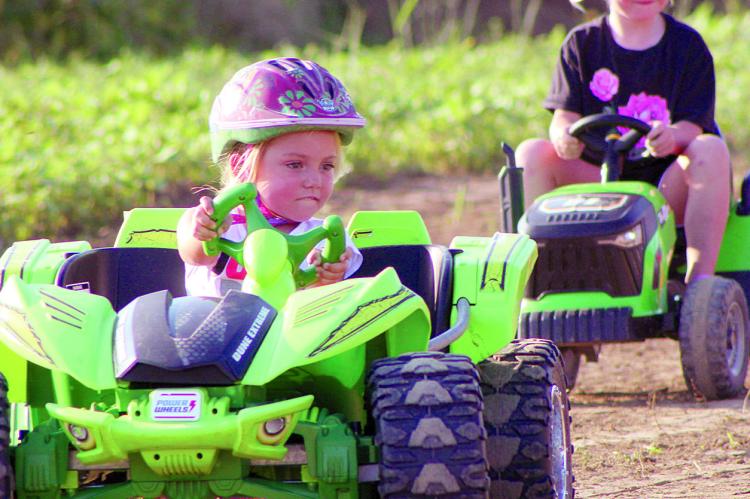 KAMERYN WILLIAMS races ahead of Kameryn Chowning during the first-ever Power Wheels racing event at the fairgrounds. SHARON DONAT | Staff