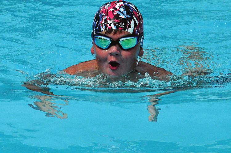 YOUNG SWIMMER Jett Shane humors the press and displays his skills at the breaststroke. SHAWN RONEY | Staff