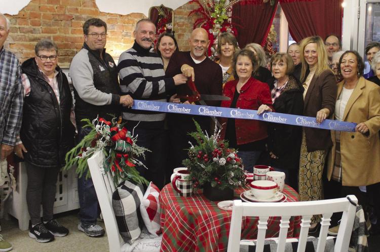 CHAMBER MEMBERS and community members gathered for a ribbon cutting at RnR Designs.