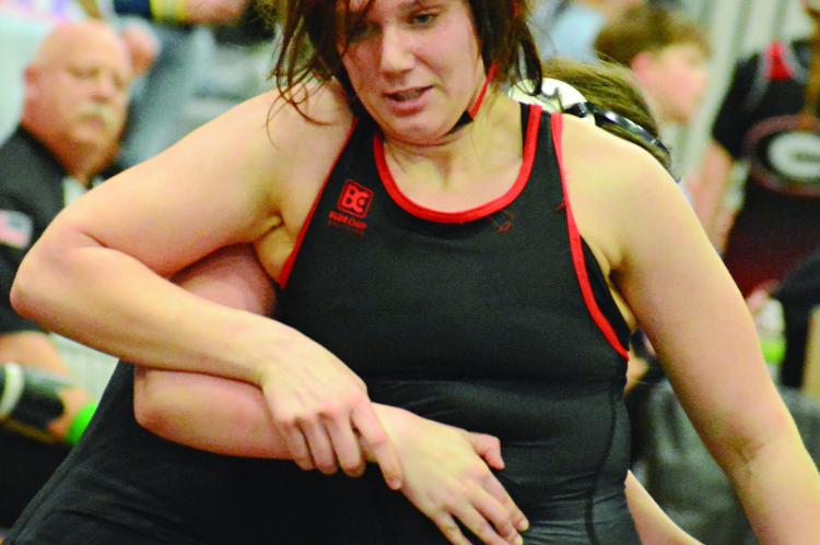 HAVING RISEN from the bottom position, Richmond sophomore Taylor Baker works to break the hold by Mid-Buchanan’s Vivian Stockbauer and score an escape during the wrestleback semifinals at the Class 1 District 4 Tournament. SHAWN RONEY | Staff