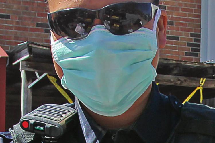 RICHMOND Police Officer Chassity Nevels wears a facemask to give out commodities. Masks are expected to help keep wearers from transmitting or being infected by COVID-19, but the state sent emergency management agencies faulty masks. J.C. VENTIMIGLIA | Staff