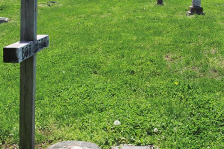 A WOODEN CROSS marks the spot in the Richmond Cemetery where Jesse James’ assassin, Robert Ford, is buried. J.C. VENTIMIGLIA | Staff