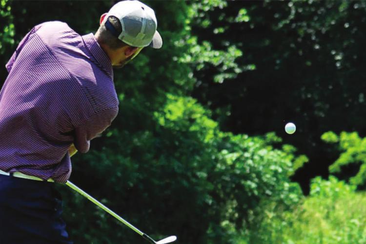 DYLAN COMSTOCK gets some loft on his golf ball Monday at Drumm Farm Golf Course in Independence. SHAWN RONEY | Staff