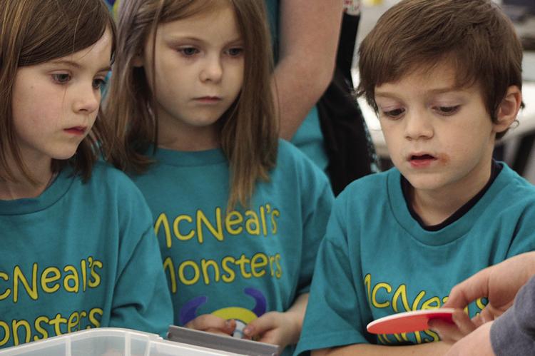 MACI HOUSER (from left), Zarya Clemens and Zeke Curtis learn to make coasters.