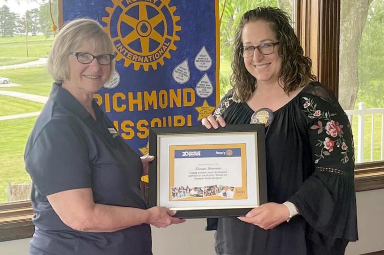MARGIE BOWMAN, left, is presented with a certificate commemorating 20 years of chairing Rotary’s Shoes for Orphan Souls program. Becky Treccariche makes the presentation.