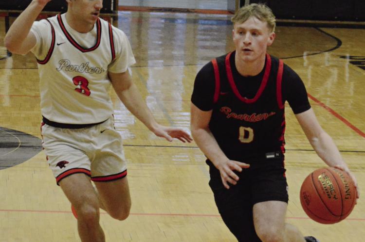 RICHMOND SENIOR Nolan Quick (right) pushes the tempo as Oak Grove senior Maddox Carillo tries to keep up with him during Class 4 District 14 boys basketball action. More game photos on page 12. SHAWN RONEY | Staff