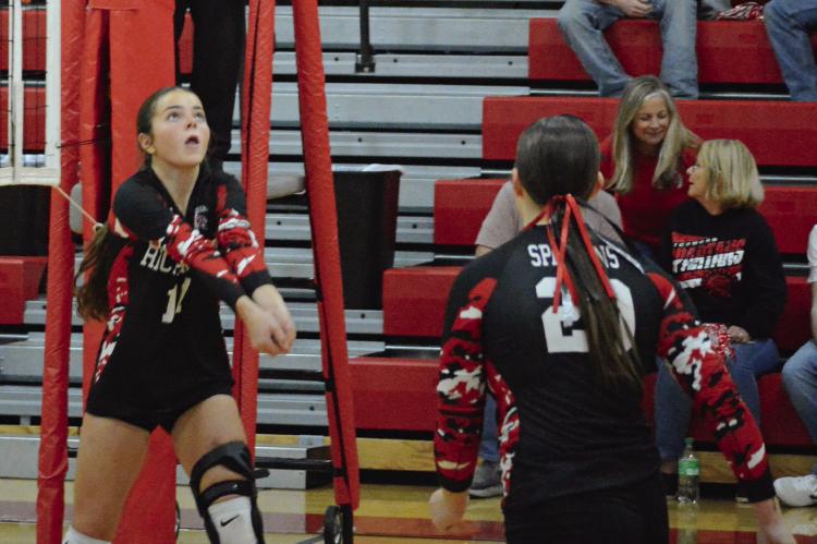 GENEVIEVE DIDIER (left) has her hands set for a bump pass as teammate Avory Oliphant watches during Richmond’s Senior Night match with Lexington. SHAWN RONEY | Staff