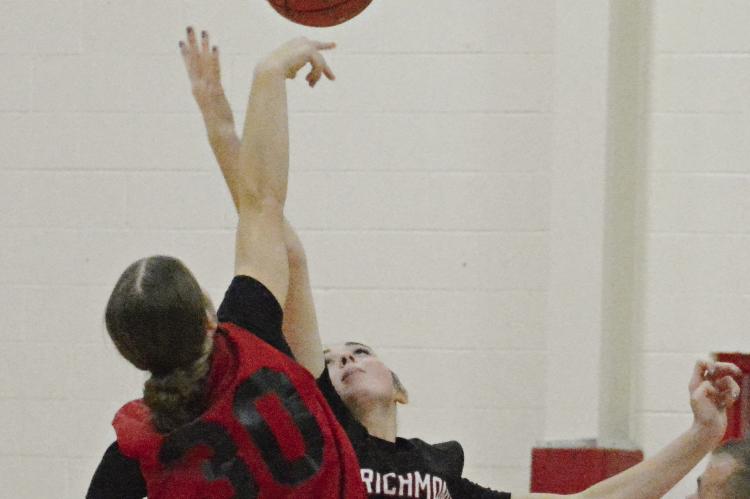 RICHMOND JUNIOR Emma Hash reaches for the opening tipoff during the Spartans’ jamboree scrimmage with Lawson.