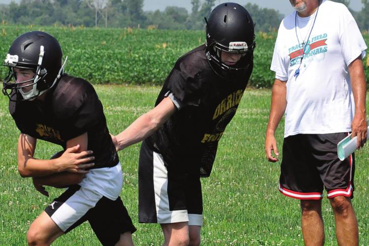 ORRICK VARSITY coach and Richmond High School alumnus Kirk Thacker watches his Bearcats work on running his “regular offense” during a team camp session Monday on the school’s practice field. The Bearcats are slated to participate in a multiteam camp Friday at Albany. SHAWN RONEY | Staff