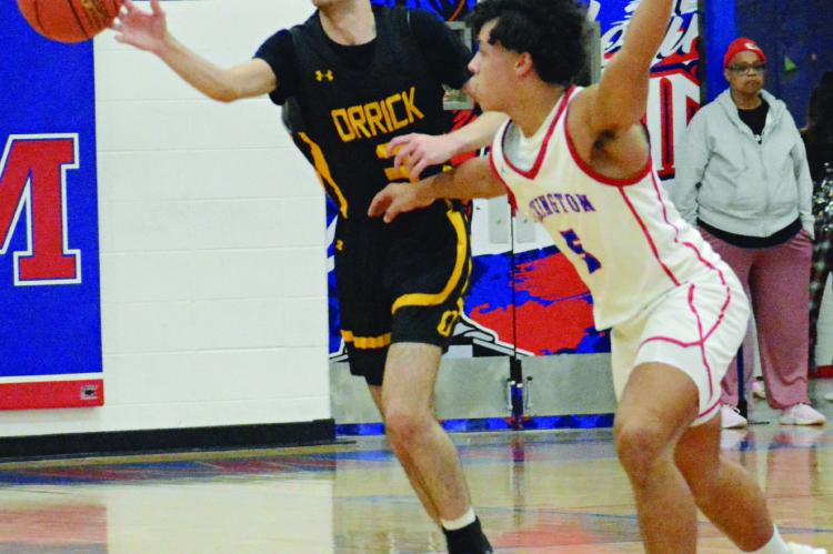 JACOB SCHARFF (left) makes a one-handed pass in Orrick’s backcourt while guarded by Zach Melvin.