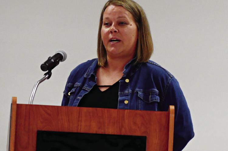 CHANTEL RIMMER THAXTON, a pioneering softball player at Richmond, addresses the crowd.