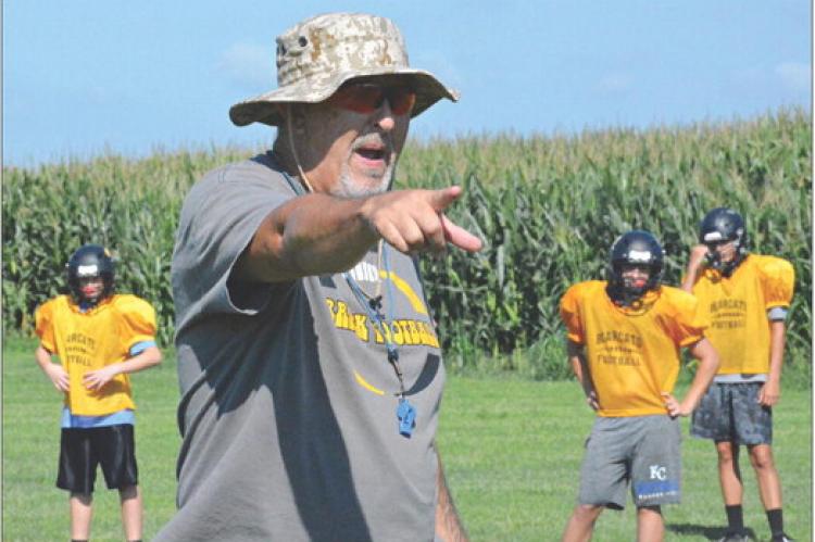 ORRICK VARSITY 8-MAN football coach Kirk Thacker, shown teaching his Bearcats as he points during an August practice, looks to get his ballclub in the win column Friday, when the Bearcats visit Concordia. SHAWN RONEY | Staff