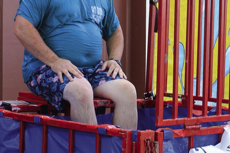 BRANDON QUICK, Richmond high school principal, lets participants dunk him during the Richmond Back to School Bash Tuesday. The dunk tank is a fundraiser for the junior class.