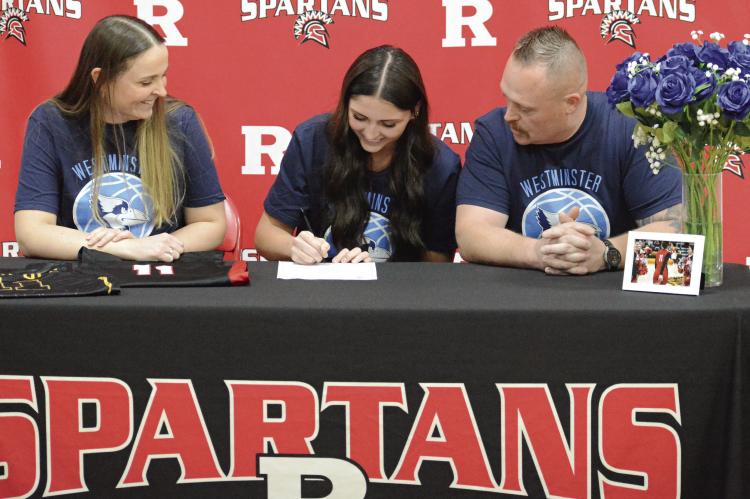 RICHMOND SENIOR Candiace Claypole literally gets her flowers on her signing day. Watching her formally express her intent to play women’s basketball at Westminster College in Fulton are parents Charmain (left) and Nathan Claypole. Story on page 12. SHAWN RONEY | Staff