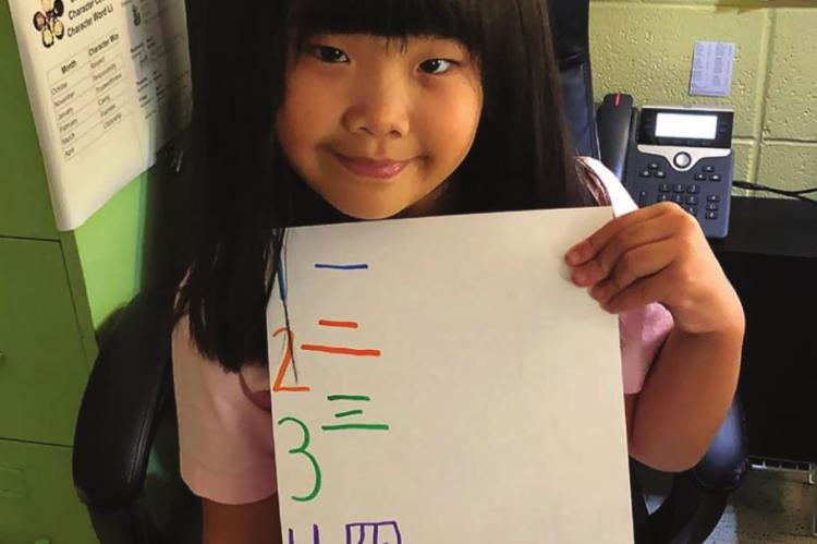 ALINA YAN helps teach numbers in Chinese.