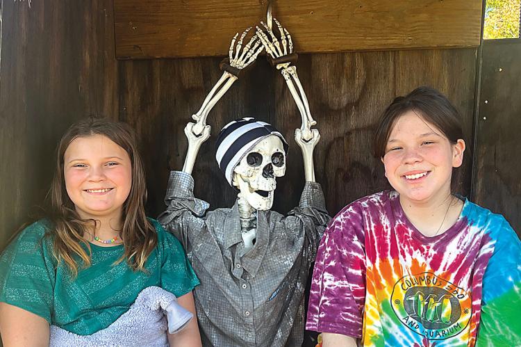 SOPHIA BALES | Staff TOP, FROM LEFT: Ireland Orr, Allisha Bales and “friend” complete the Escape Room On Wheels with Inside Out Escape Entertainment from Excelsior Springs that’s feautred at the sheriff's domestic violence event.